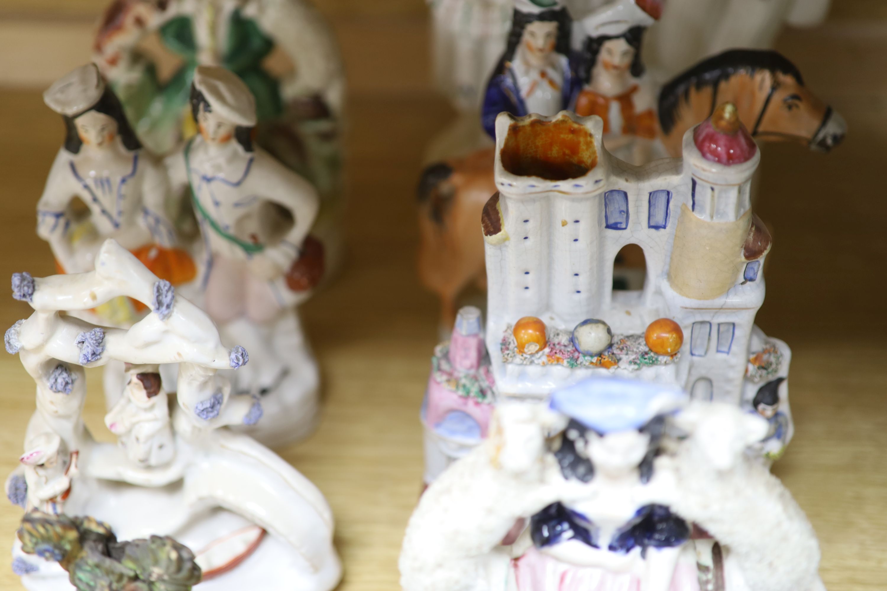 A collection of 19th century Staffordshire flatbacks, including an early 19th century Staffordshire pearlware deer, tallest 33cm